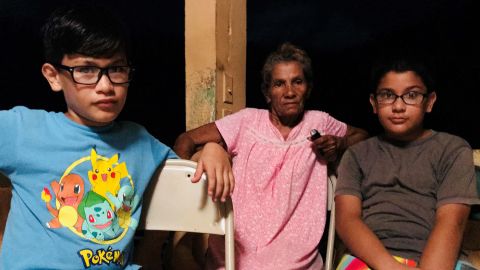 Ediel Rivera, right, with his cousin and grandmother, says sometimes there is nothing to do but stare at each other.