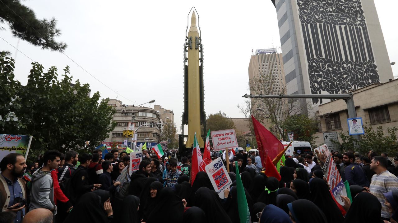 Iranians gather Saturday outside the ex-US Embassy in Tehran with a medium-range missile on display.