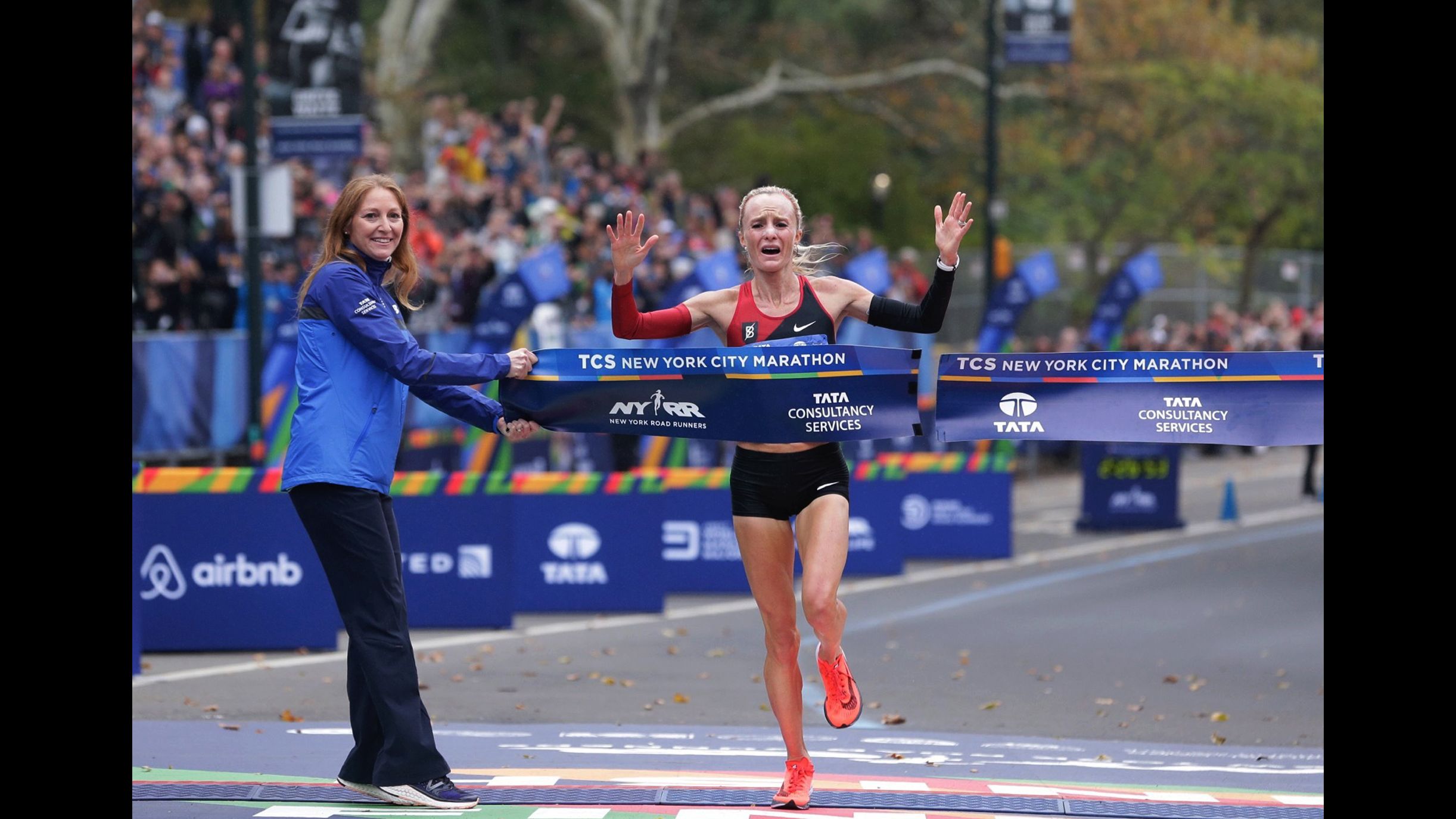 Shalane Flanagan crosses the finish line first in the women's division of the New York City Marathon.