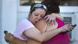 Carrie Matula embraces a woman after a fatal shooting at the First Baptist Church in Sutherland Springs, Texas, on Sunday, Nov. 5, 2017. Matula said she heard the shooting from the gas station where she works a block away. (Nick Wagner/Austin American-Statesman via AP)