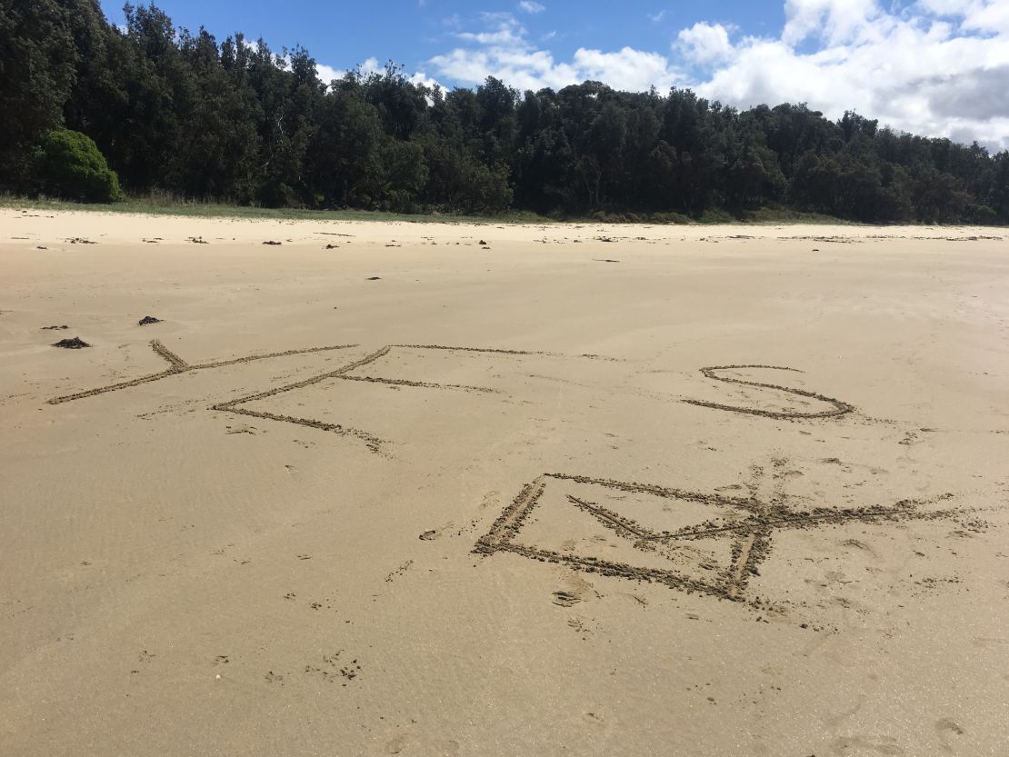 Melissa, Ebony and their family leave a message on the sands of Cape Conran, Victoria, on October 14.