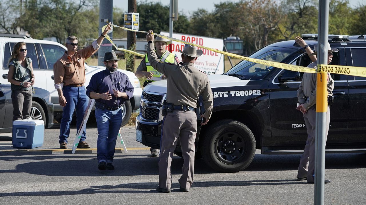 Law enforcement officers man a barricade near the church.