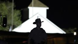 A law enforcement official walks past the First Baptist Church of Sutherland Springs, the scene of a mass shooting, Sunday, Nov. 5, 2017, in Sutherland Springs, Texas. (AP Photo/Eric Gay)