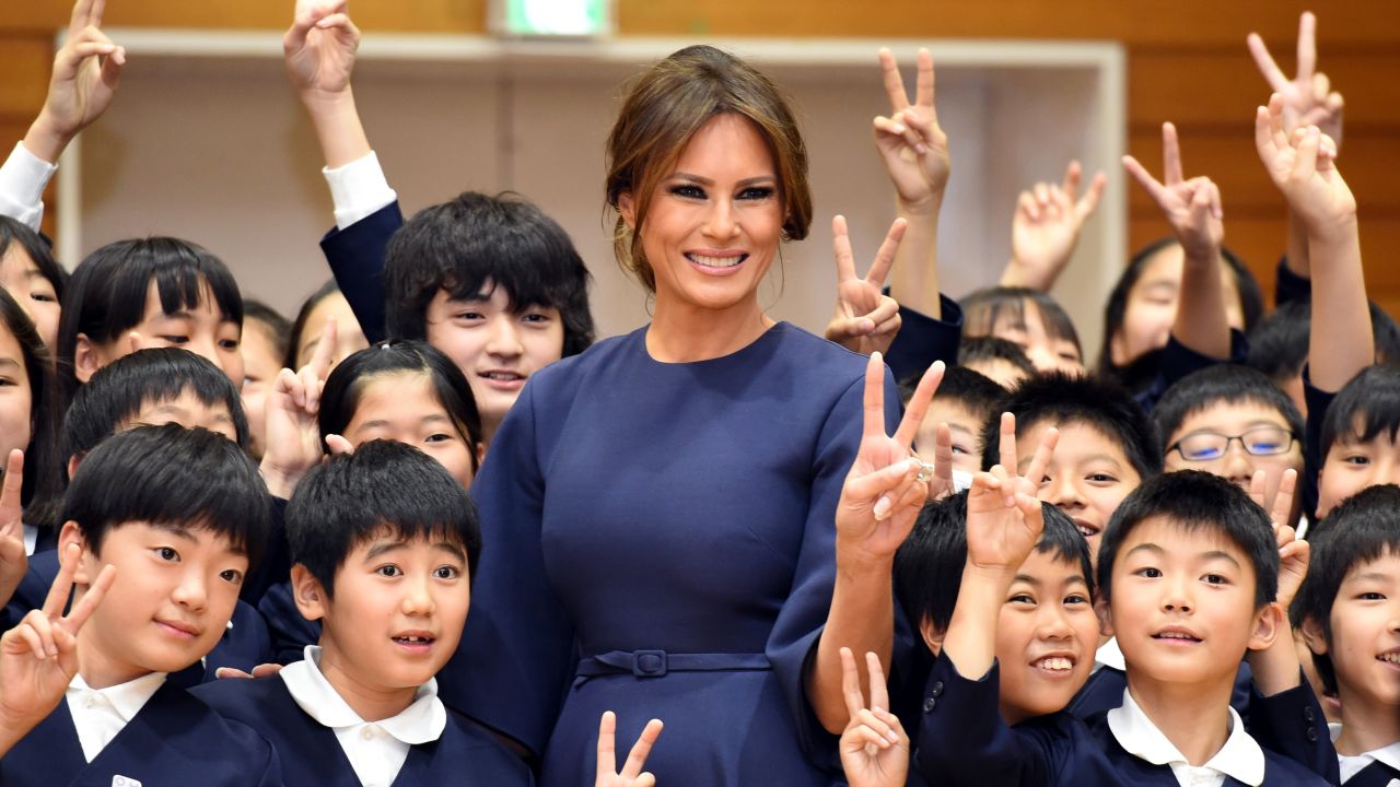 US First Lady Melania Trump poses with 4th graders at the Kyobashi Tsukiji elementary school in Tokyo on November 6, 2017.
President Donald Trump lashed out at the US trade relationship with Japan, saying it was "not fair and open", as he prepared for formal talks with his Japanese counterpart. / AFP PHOTO / POOL / PING MA        (Photo credit should read PING MA/AFP/Getty Images)