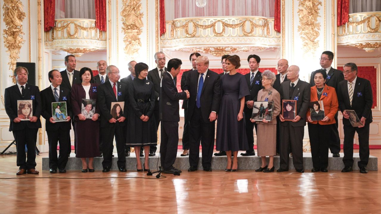 US President Donald Trump speaks beside the families of abductees at the Akasaka Palace on Monday.