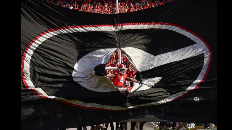 Georgia wide receiver Mecole Hardman Jr. breaks through a banner before a college football game against South Carolina on Saturday, November 4. Georgia is the No. 1 team in the College Football Playoff rankings.