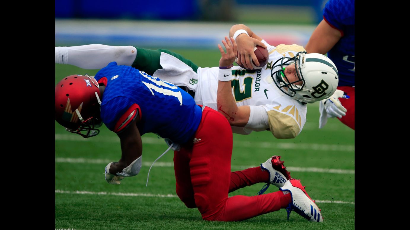 Baylor quarterback Charlie Brewer is tackled by Kansas cornerback Kyle Mayberry during a college football game in Lawrence, Kansas, on Saturday, November 4.