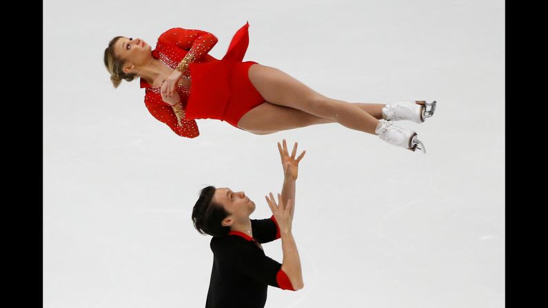 Michael Marinaro tosses Kirsten Moore-Towers into the air during the Cup of China, a Grand Prix figure-skating event in Beijing on Friday, November 3. The Canadian pair finished in third place.