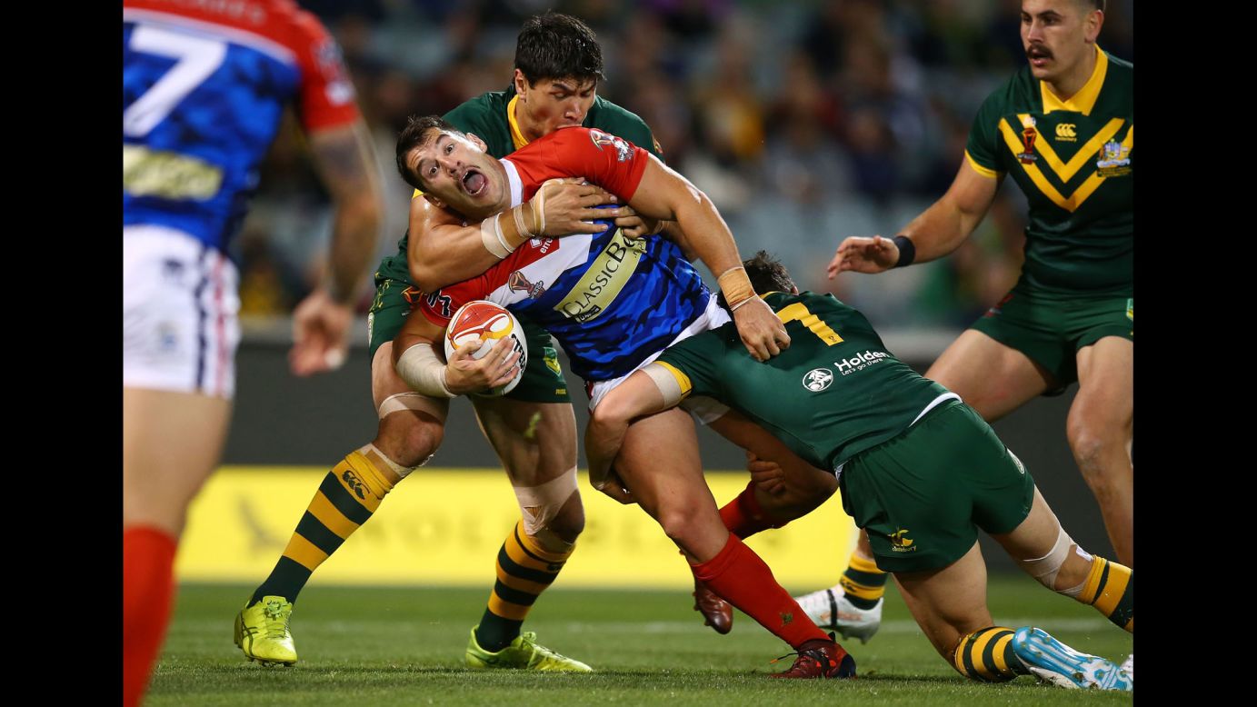 France's Benjamin Garcia is tackled by Australian players during a Rugby League World Cup match on Friday, November 3.