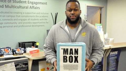 Rahk Lash holds a physical replica of the "man box."