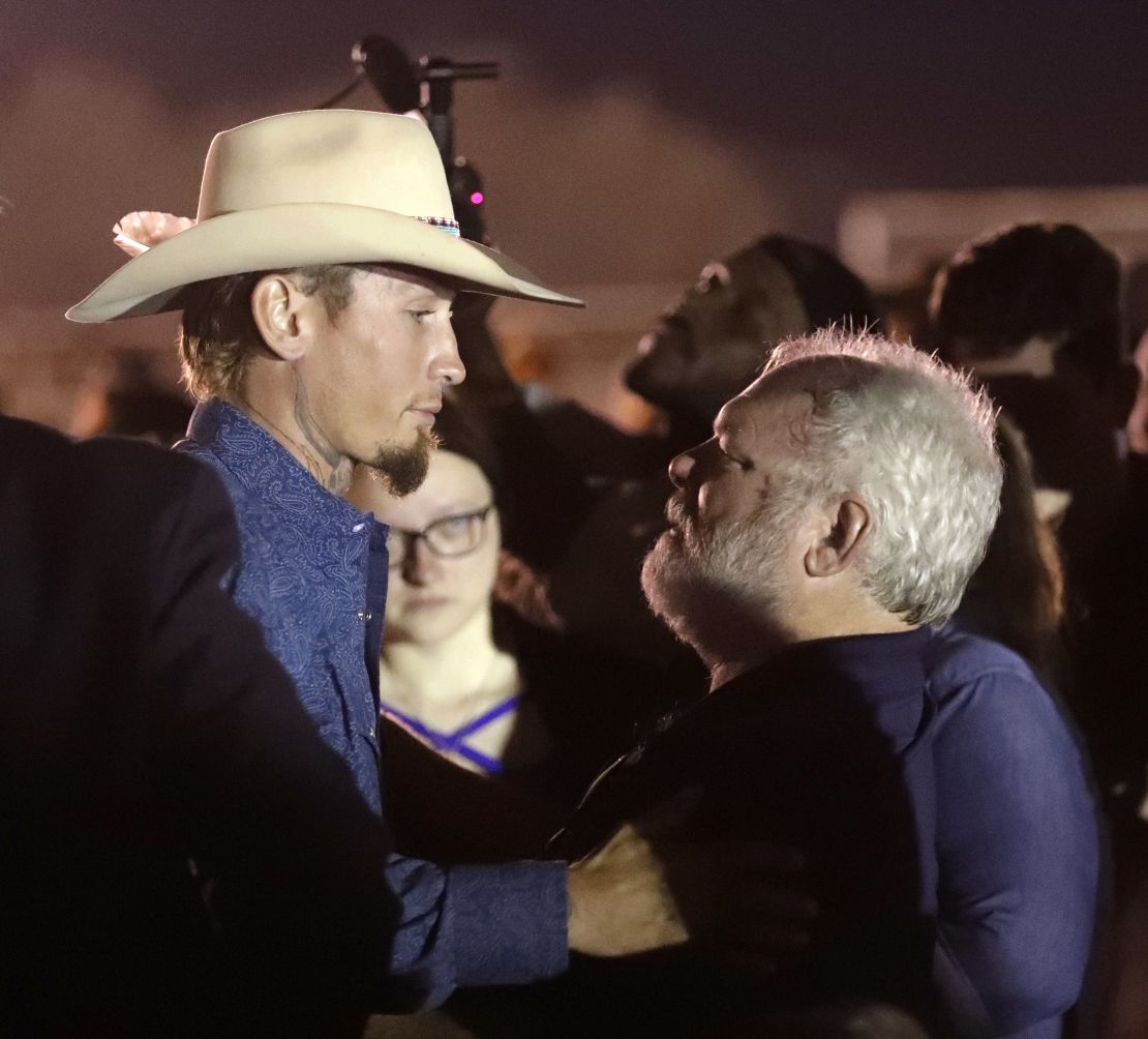 Stephen Willeford, right, meets Johnnie Langendorff at a vigil Monday for the shooting victims.