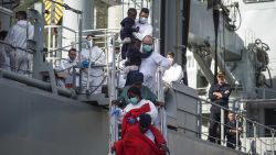 SALERNO, ITALY - NOVEMBER 05: Rescued migrants disembark from the Spanish navy ship 'Cantabria' on November 5, 2017 in Salerno, Italy. The Spanish ship rescued around 400 migrants two days ago in the Mediterranean Sea, those onboard included 259 men and 116 women, of which 9 pregnant and 26 were dead. (Photo by Antonio Masiello/Getty Images)