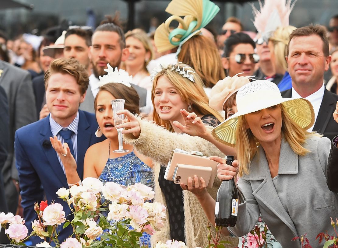 Fans cheer on the horses during Melbourne Cup Day at Flemington Racecourse in 2017.