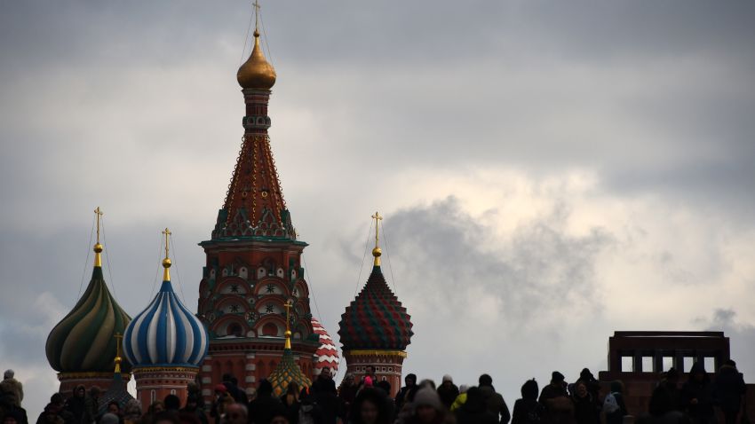 People cross Red Square with St. Basil's Cathedral seen in the background in Moscow on February 11, 2017. / AFP / VASILY MAXIMOV        (Photo credit should read VASILY MAXIMOV/AFP/Getty Images)