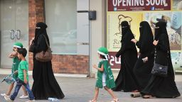 Saudi women and their children walk along a street as they make their way to a celebration rally marking the 83rd Saudi Arabian National Day in the desert kingdom's capital Riyadh, on September 23, 2013.    AFP PHOTO/FAYEZ NURELDINE        (Photo credit should read FAYEZ NURELDINE/AFP/Getty Images)