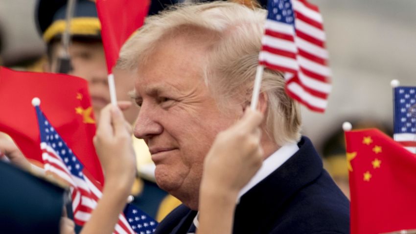 Children wave U.S. and Chinese flags as President Donald Trump arrives at Beijing Airport, Wednesday, Nov. 8, 2017, in Beijing, China. Trump is on a five country trip through Asia traveling to Japan, South Korea, China, Vietnam and the Philippines. (AP Photo/Andrew Harnik)