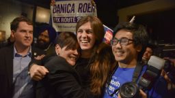 Danica Roem, center, who ran for house of delegates against GOP incumbent Robert Marshall, is greeted by supporters as she prepares to give her victory speech with Prince William County Democratic Committee at Water's End Brewery on Tuesday, Nov. 7, 2017, in Manassas, Va. Roem will be the first openly transgender person elected and seated in a state legislature in the United States. (Jahi Chikwendiu/The Washington Post via AP)