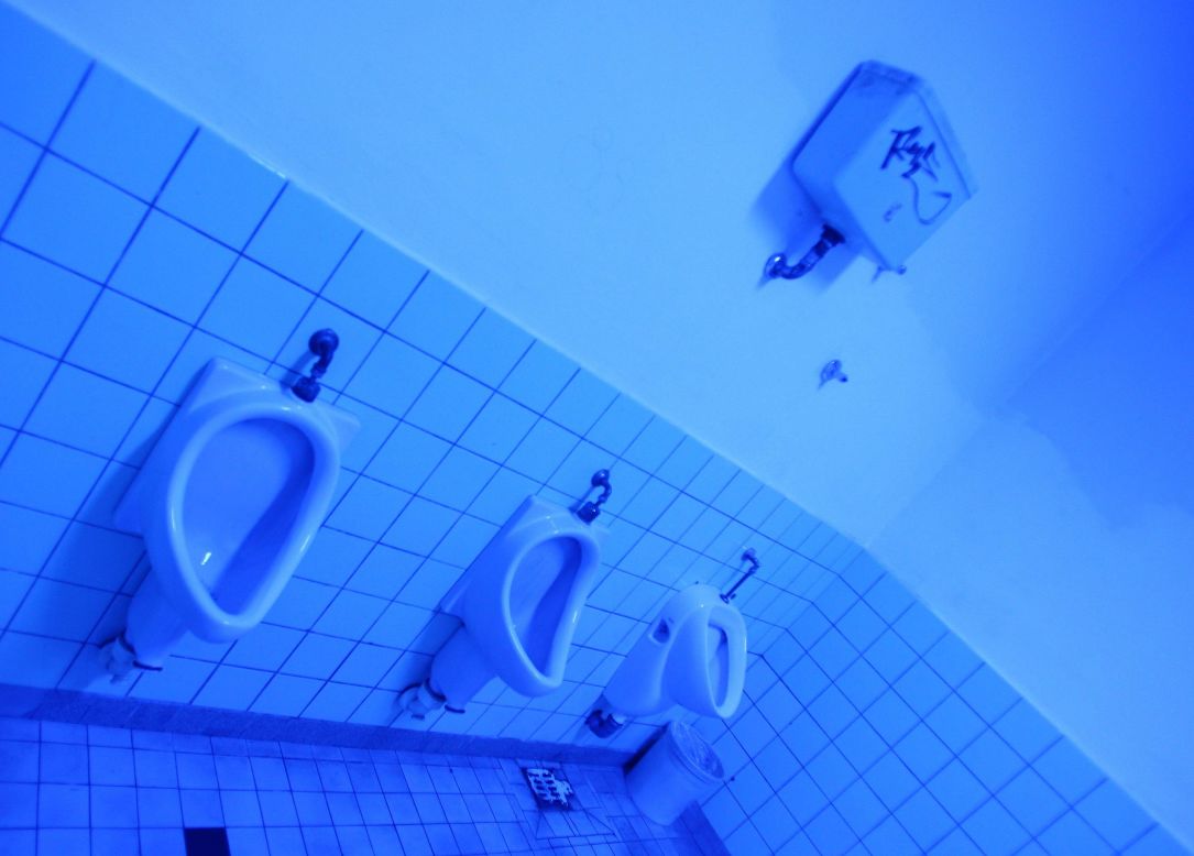 This men's room is illuminated with ultraviolet light, which makes it impossible for heroin addicts to find a vein. However, the uncomfortable lighting doesn't only deter drug addicts and dealers -- it also creates an unpleasant atmosphere for other visitors.