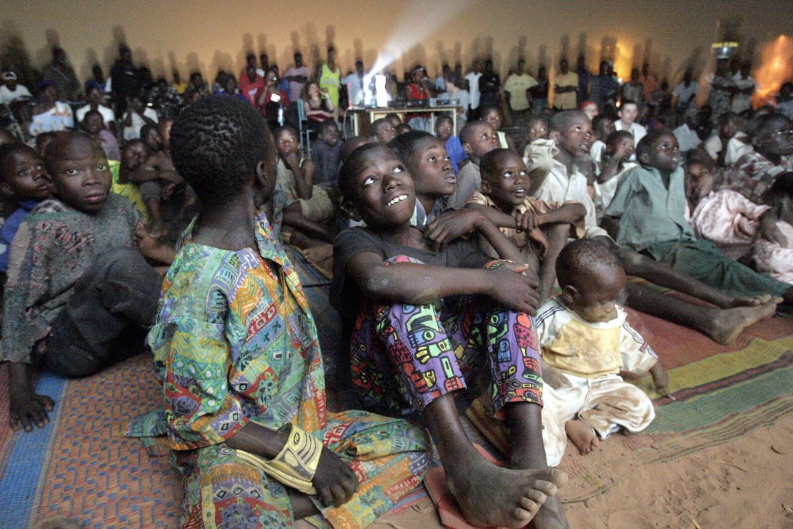 Children watch a documentary on the fringes of FESPACO in Ouagadougou, Burkina Faso, 2005.