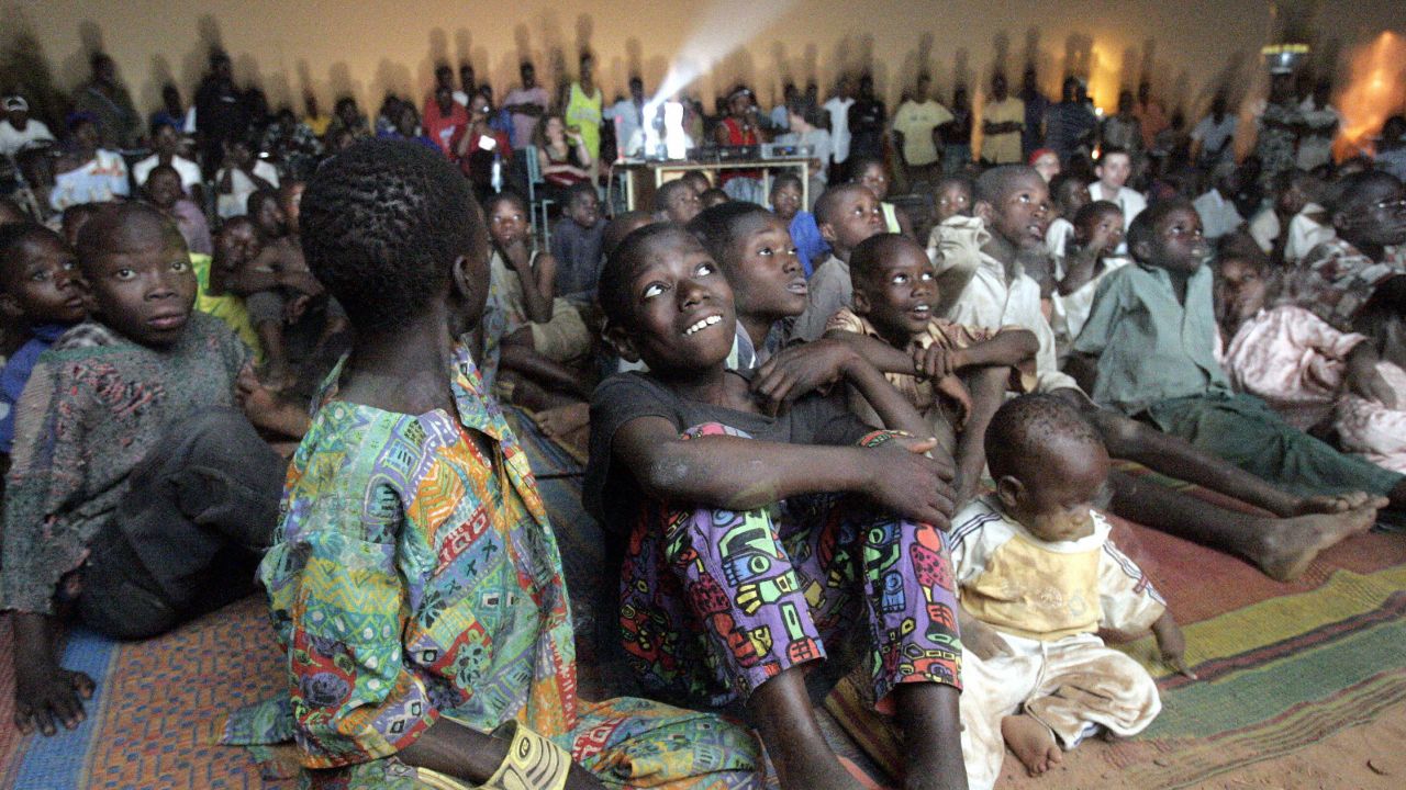 Children watch a documentary on the fringes of FESPACO in Ouagadougou, Burkina Faso, 2005.