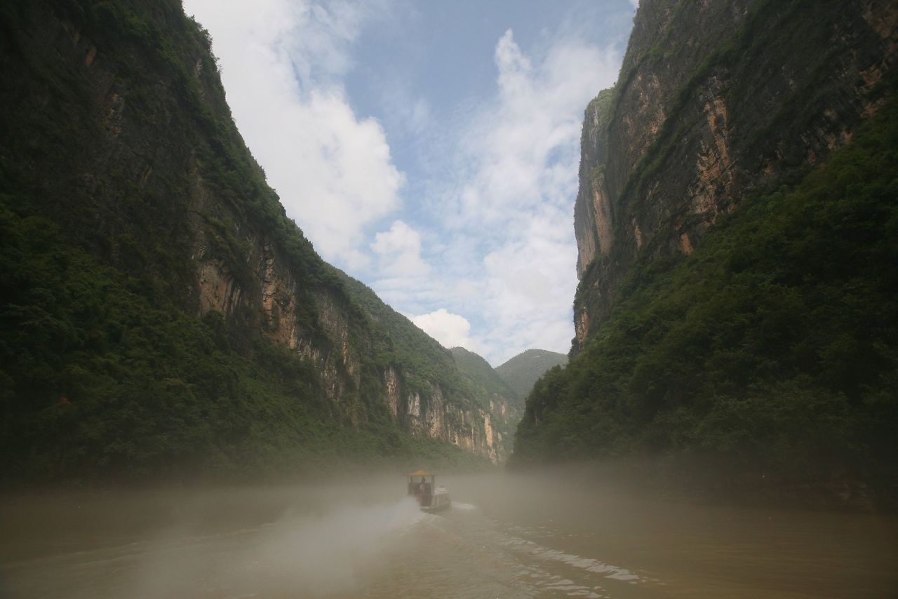 <strong>Misty Gorge:</strong>  A boat sails through Misty Gorge, one of the so-called "Three Mini Gorges," near Wushan on the Yangtze River.