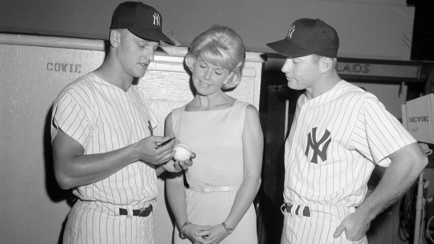 Baseball stars Roger Maris, left, and Mickey Mantle talk with Day on the set of "That Touch of Mink" in 1961.
