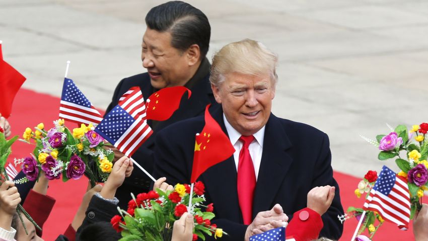U.S. President Donald Trump, right, and Chinese President Xi Jinping are greeted by children waving flowers and flags during a welcome ceremony at the Great Hall of the People in Beijing, Thursday, Nov. 9, 2017. (AP Photo/Andy Wong)