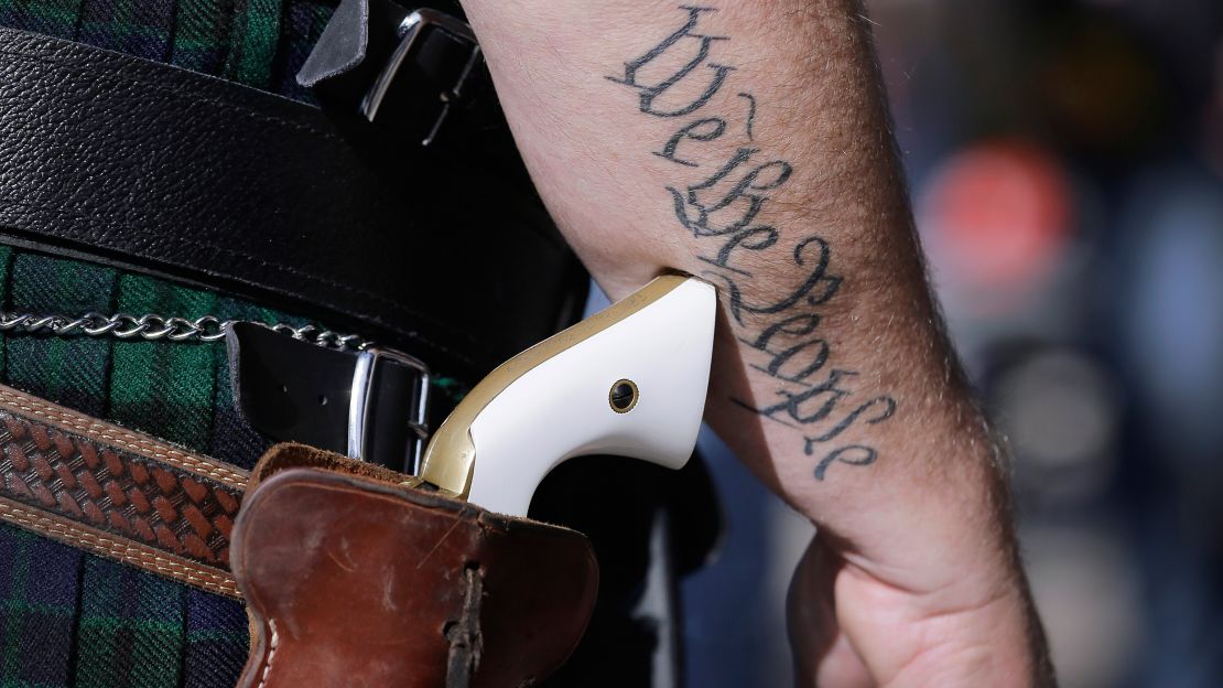 A supporter of open carry gun laws wears a pistol at a rally at the state Capitol in Austin.