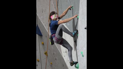 Communicating by headset, guides describe to blind climbers where their feet and hands are in relation to a given hold. 