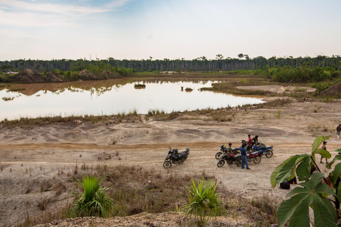 A group of motorcycle taxis known as "Los Tigres" stops near a toxic mining site in the Peruvian Amazon.
