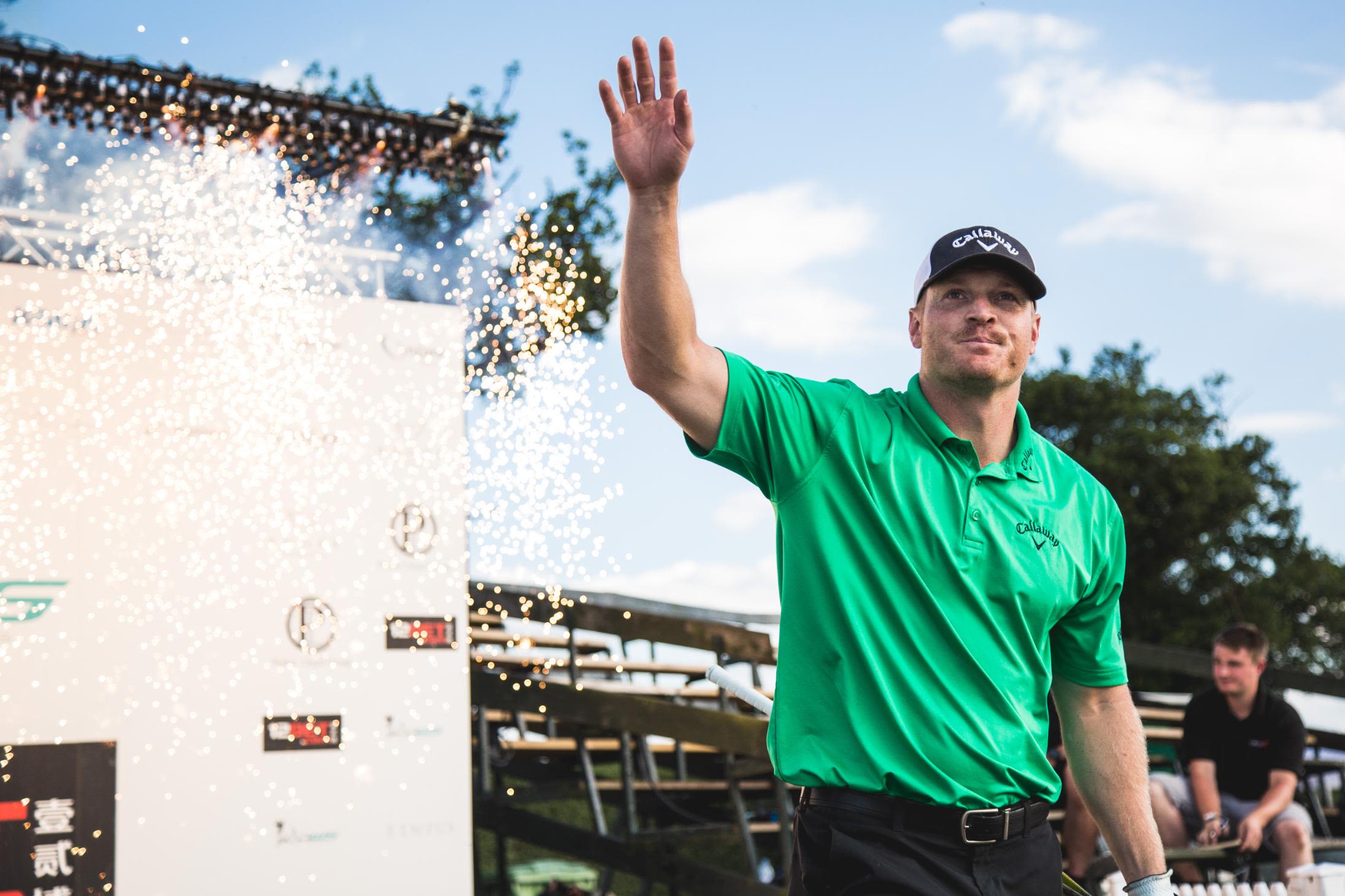 American power hitter Will Hogue greets the crowd at a Long Drive World Series event staged at a polo club in Windsor, UK. Organizers are adding a bit of sparkle to proceedings, including pyrotechnics when the players walk onto the tee and after they smash their drives. 