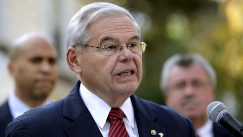 U.S. Sen. Bob Menendez speaks on the yard of Peter Tom, a New Jersey resident, during a news conference talking about the tax-overhaul plan unveiled by House Republicans, Friday, Nov. 3, 2017, in Bloomfield, N.J. (AP Photo/Julio Cortez)