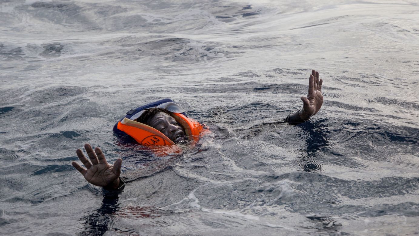 A migrant tries to board the boat of Sea-Watch, a German aid group, during a rescue operation in the Mediterranean Sea on Monday, November 6.