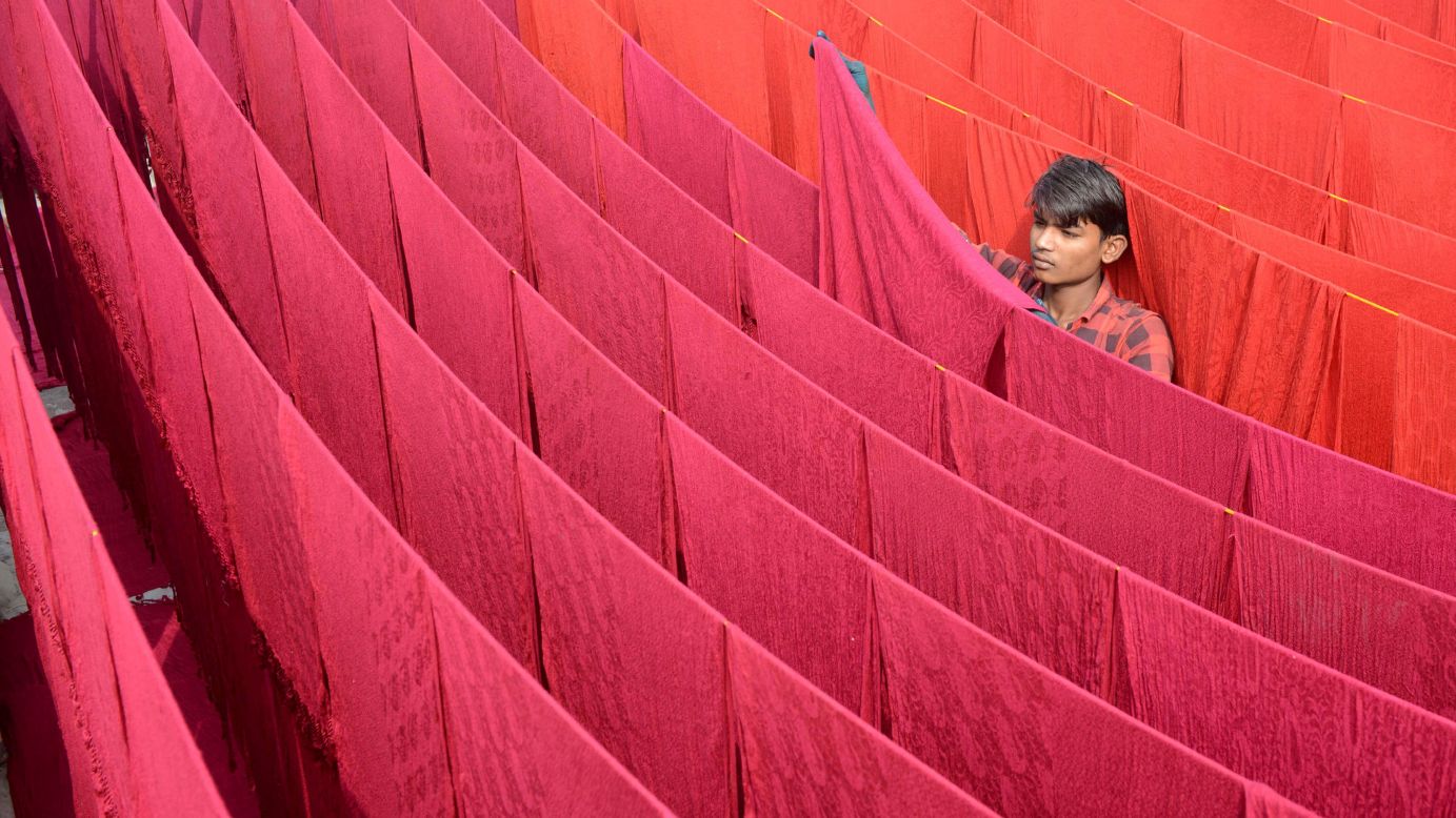 An artisan dries stoles after dyeing them in Amritsar, India, on Sunday, November 5.