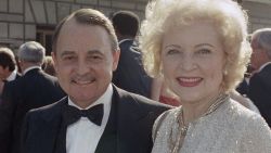 FILE- This Sept. 22, 1985, file photo shows John Hillerman, left, and Betty White, right, arriving at Emmy Awards in Pasadena, Calif. (AP Photo/LIU, File)