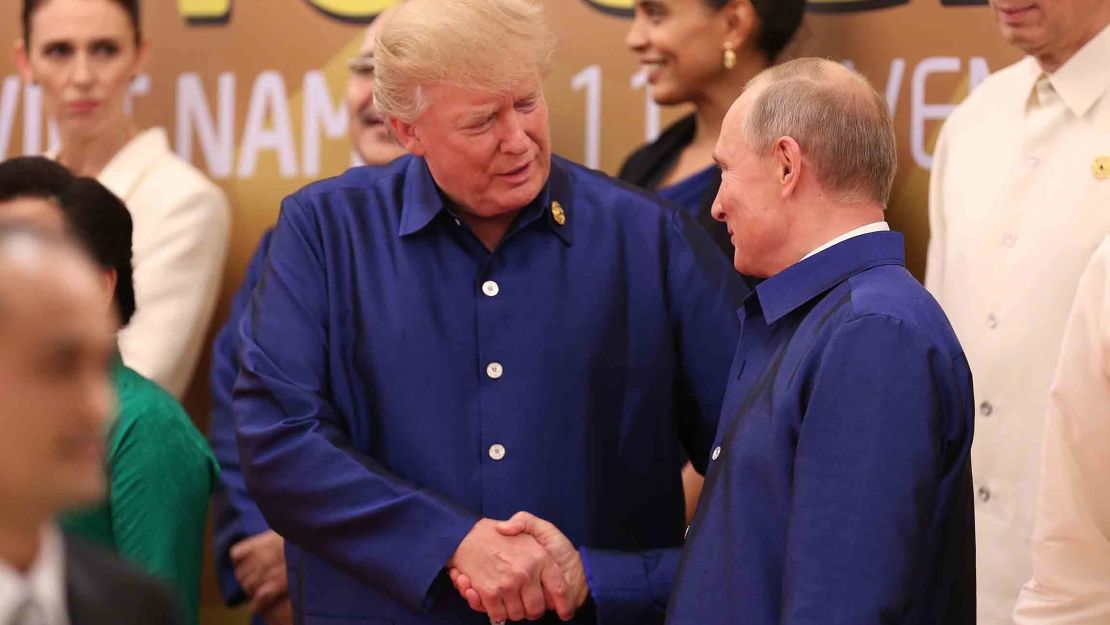 US President Donald Trump shakes hands with Russia's President Vladimir Putin (R) as they pose for a group photo ahead of the Asia-Pacific Economic Cooperation Summit leaders gala dinner in Vietnam in November.