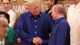 US President Donald Trump (L) shakes hands with Russia's President Vladimir Putin (R) as they pose for a group photo ahead of the Asia-Pacific Economic Cooperation (APEC) Summit leaders gala dinner in the central Vietnamese city of Danang on November 10, 2017.
World leaders and senior business figures are gathering in the Vietnamese city of Danang this week for the annual 21-member APEC summit. / AFP PHOTO / Vietnam News Agency / STR        (Photo credit should read STR/AFP/Getty Images)
