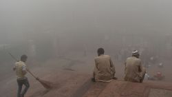 Indian visitors sit on the steps outside Jama Masjid amid heavy smog in the old quarters of New Delhi on November 8, 2017.
Delhi shut all primary schools on November 8 as pollution levels hit nearly 30 times the World Health Organization safe level, prompting doctors in the Indian capital to warn of a public health emergency. Dense grey smog shrouded the roads of the world's most polluted capital, where many pedestrians and bikers wore masks or covered their mouths with handkerchiefs and scarves.
 / AFP PHOTO / Sajjad HUSSAIN        (Photo credit should read SAJJAD HUSSAIN/AFP/Getty Images)