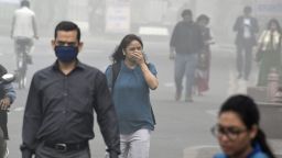 Indian people walk on a street as heavy smogs covers New Delhi on November 8, 2017.
Delhi shut all primary schools on November 8 as pollution levels hit nearly 30 times the World Health Organization safe level, prompting doctors in the Indian capital to warn of a public health emergency. Dense grey smog shrouded the roads of the world's most polluted capital, where many pedestrians and bikers wore masks or covered their mouths with handkerchiefs and scarves.
 / AFP PHOTO / DOMINIQUE FAGET        (Photo credit should read DOMINIQUE FAGET/AFP/Getty Images)