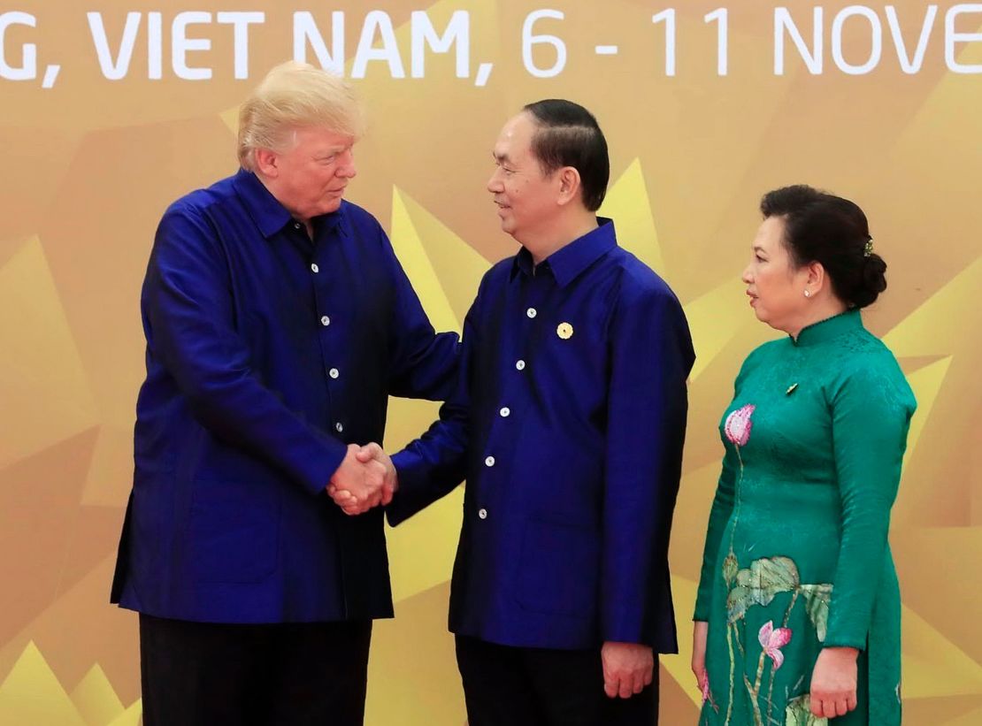US President Donald Trump shakes hands with Vietnamese President Tran Dai Quang upon arrival for the Asia-Pacific Economic Cooperation (APEC) Summit