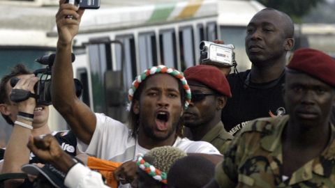 Drogba is seen boarding a military vehicle at Félix Houphouet Boigny Airport in October 2005 after qualifying for the World Cup.
