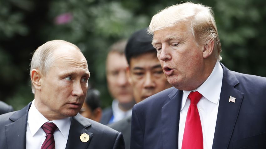 US President Donald Trump (R) and Russia's President Vladimir Putin talk as they make their way to take the "family photo" during the Asia-Pacific Economic Cooperation (APEC) leaders' summit in the central Vietnamese city of Danang on November 11, 2017.
World leaders and senior business figures are gathering in the Vietnamese city of Danang this week for the annual 21-member APEC summit. / AFP PHOTO / POOL / JORGE SILVA        (Photo credit should read JORGE SILVA/AFP/Getty Images)