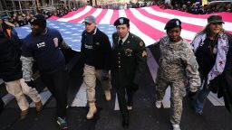 NEW YORK, NY - NOVEMBER 11:  Soldiers, veterans and civilians carry an American Flag as they march in the Veterans Day Parade on November 11, 2017 in New York City. The largest Veterans Day event in the nation, this year's parade features thousands of marchers, including military units, civic and youth groups, businesses and high school bands from across the country and veterans of all eras. The U.S. Air Force is this year's featured service and the grand marshal is space pioneer Buzz Aldrin.  (Photo by Spencer Platt/Getty Images)