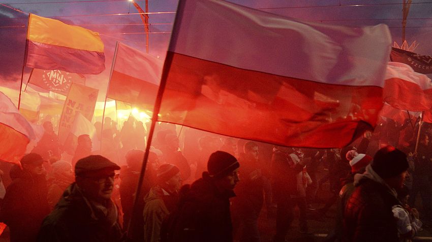 Demonstrators burn flares and wave Polish flags during the annual march to commemorate Poland's National Independence Day in Warsaw, Saturday, Nov. 11, 2017.  Thousands of nationalists marched in Warsaw on Poland's Independence Day holiday, taking part in an event that was organized by far-right groups. (AP Photo/Czarek Sokolowski)