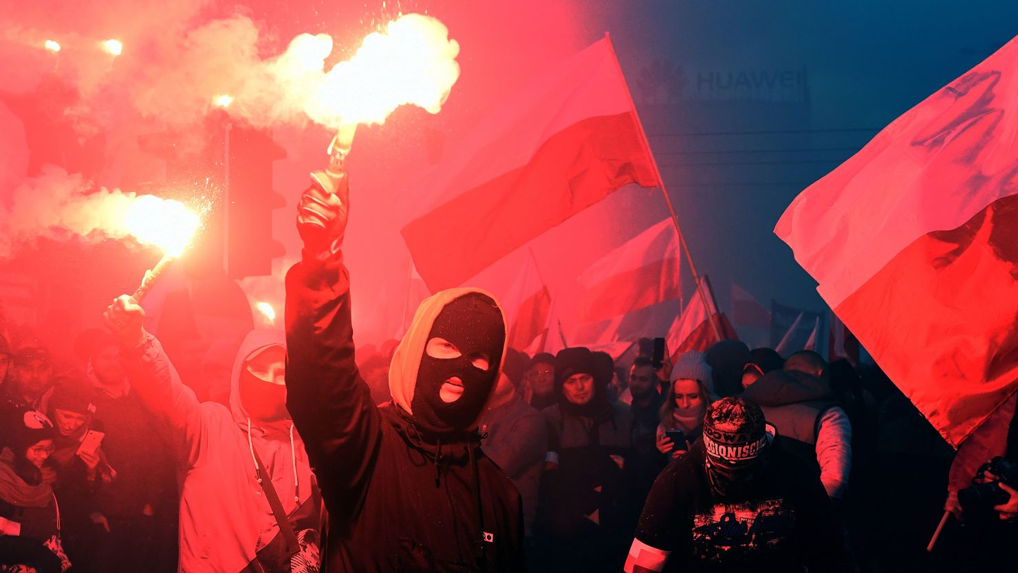 Demonstrators burn flares and wave Polish flags in last year's independence day march.