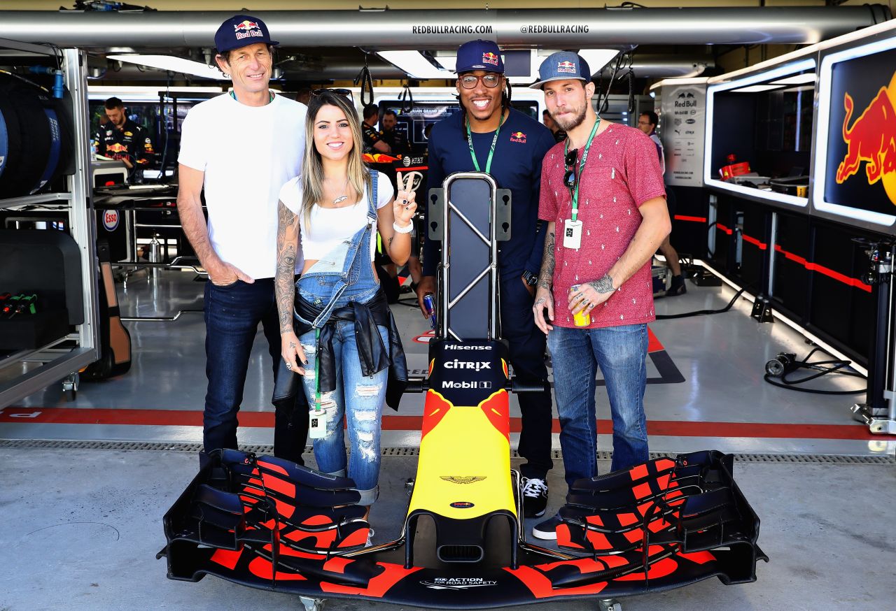 Skateboarder Leticia Bufoni, climber Felipe Camargo, Capoeira master Artur Fiu and TV superstar Felipe Titto pose for a photo outside the Red Bull Racing garage ahead of the race. 