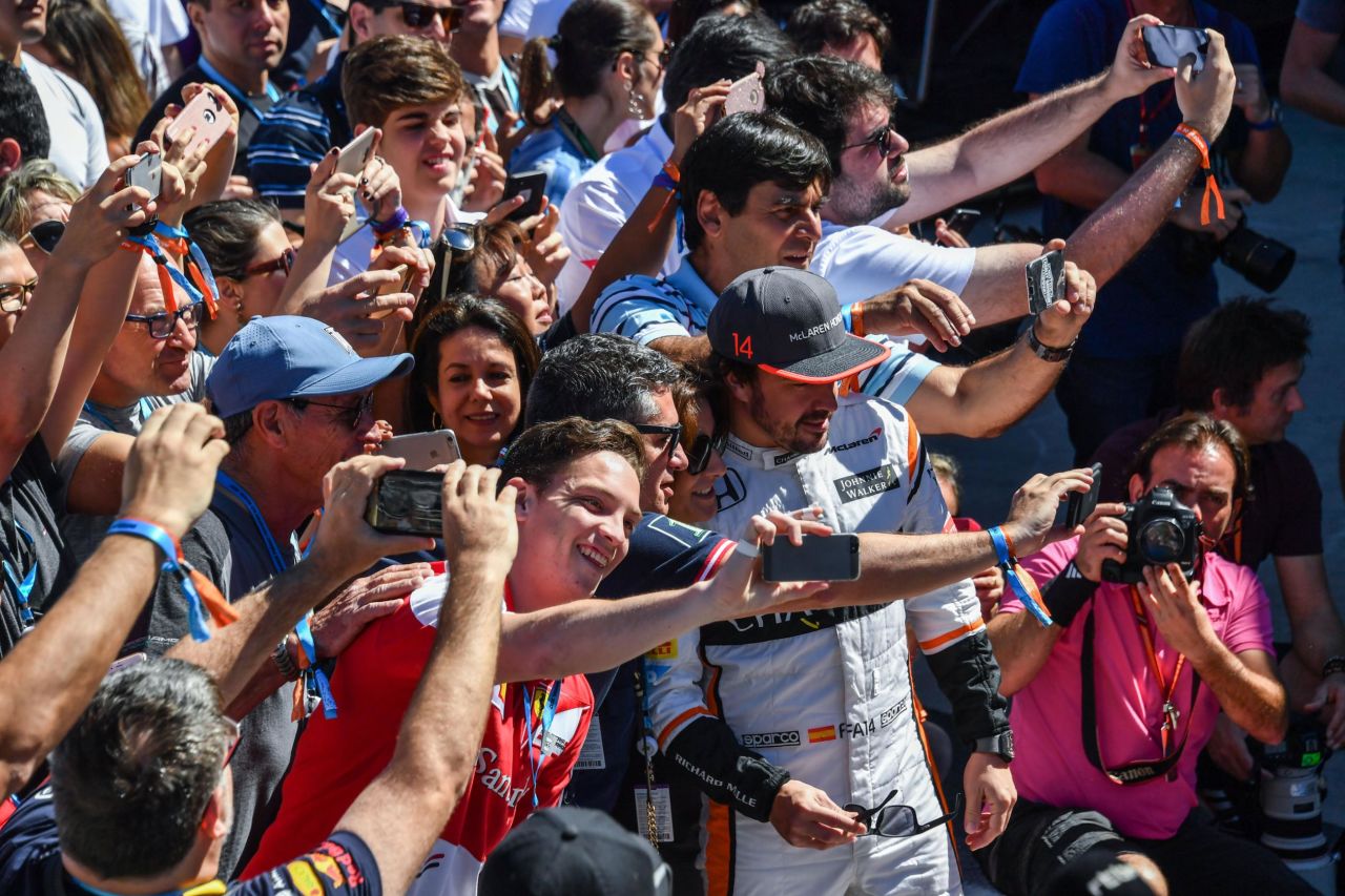 Fernando Alonso poses with fans ahead of Sunday's race. The McLaren driver started from P6 on the grid -- his highest-ever position on the grid since returning to the British team in 2015.  