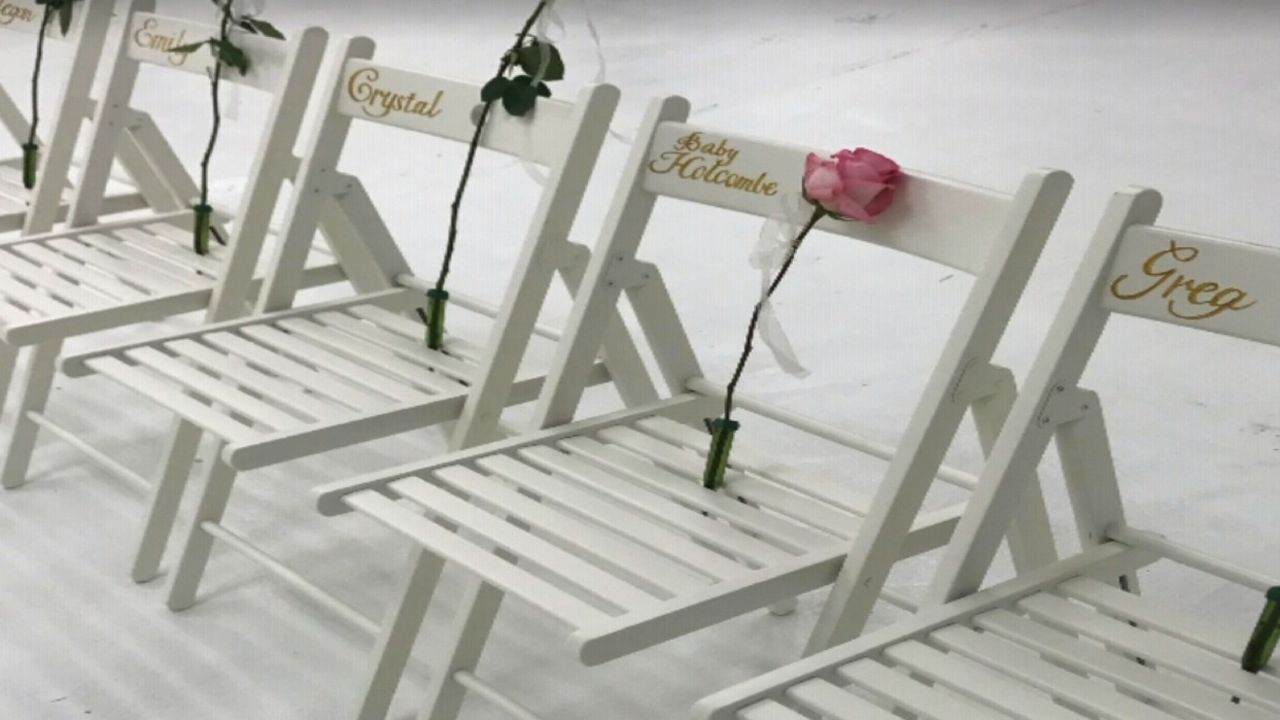A single pink rose was placed on a chair in honor of the unborn child. 