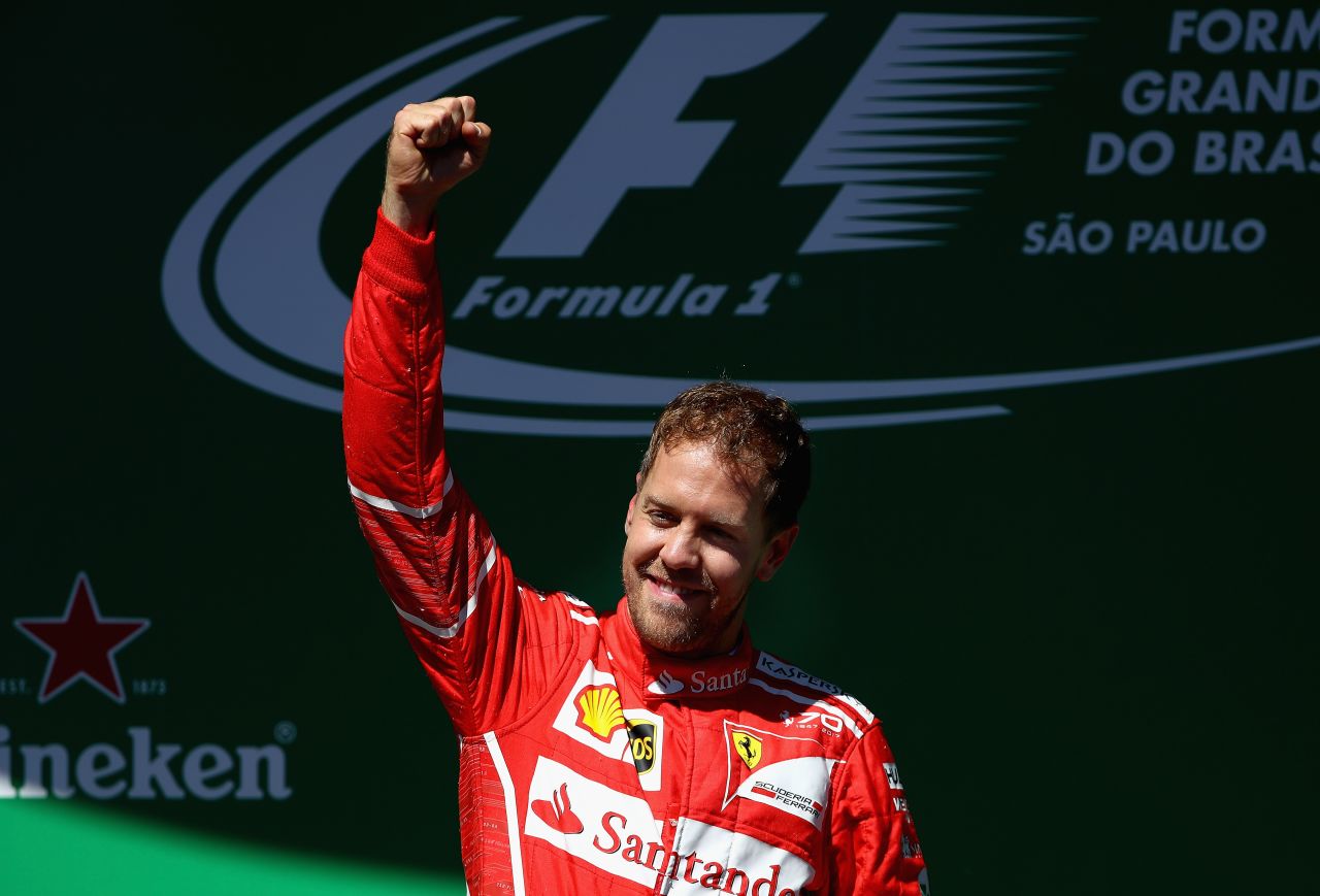 Ferrari's Sebastian Vettel raises a triumphant fist after winning Sunday's race at Interlagos.