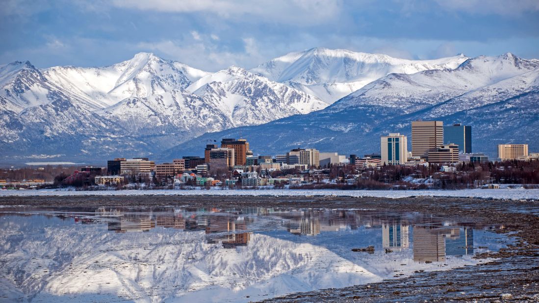 <strong>December in Anchorage, Alaska:</strong> Buildings stand illuminated in front of the Chugach Mountains outside Anchorage, Alaska. Hardy visitors from more southerly climes get to experience what it's like to have really short days and really long nights here.